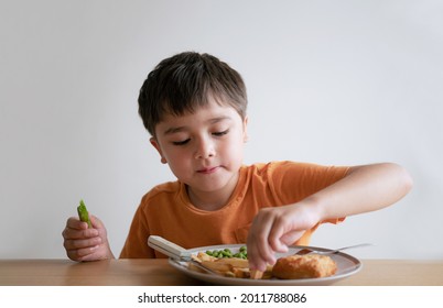 Portrait Of 7-8 Year Old Kid Boy Having Homemade Fish Finger And French Fries For Sunday Dinner At Home, A Happy Child Eating Lunch, Children Eating Heathy And Fresh Food, Healthy Life Style Concept