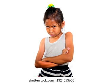 Portrait Of 8 Or 9 Years Old Sweet Sad And Upset Mixed Ethnicity Child Feeling Unhappy Posing Moody With Folded Arms Isolated On White Background In Young Girl Suffering Bullying At School