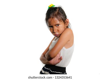 Portrait Of 8 Or 9 Years Old Sweet Sad And Upset Mixed Ethnicity Child Feeling Unhappy Posing Moody With Folded Arms Isolated On White Background In Young Girl Suffering Bullying At School