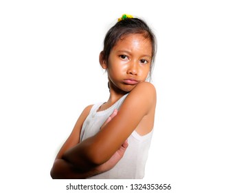 Portrait Of 8 Or 9 Years Old Sweet Sad And Upset Mixed Ethnicity Child Feeling Unhappy Posing Moody With Folded Arms Isolated On White Background In Young Girl Suffering Bullying At School