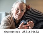 Portrait of an 86 yo grandmother embracing her daughter in Tienen, Flemish Brabant, Belgium