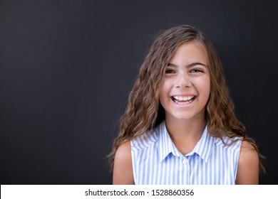 Portrait Of A 9 Years Old Female Child With Black Background (dark), Portrait Concept Of A Child