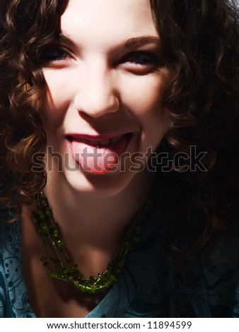 Young happy woman sticking out her tongue