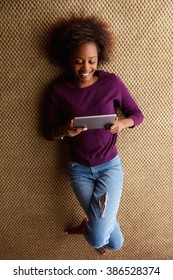 Portrait From Above Young Black Woman Lying Down With Digital Tablet