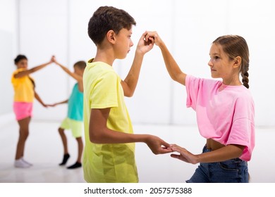 Portrait Of Active Children Enjoying Of Partner Dance In Class