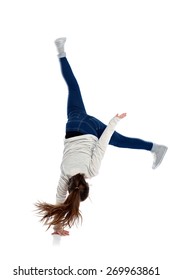Portrait of active girl making one handed cartwheel on white background