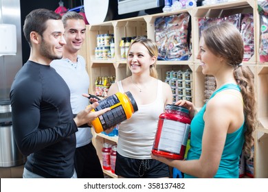 Portrait Of Active People With Sport Nutrition Products In Shop 