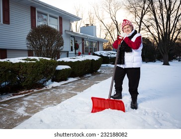 Portrait Of Active Senior Citizen With Snow Shovel (Wide Perspective Showing More Of Sidewalk)