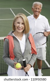 Portrait Of An Active Senior Couple On The Tennis Court