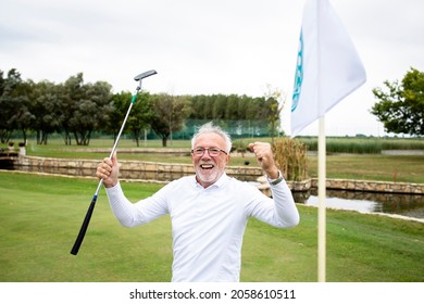 Portrait of an active senior man celebrating winning at the golf course and enjoying free time outdoors.