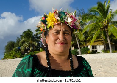 Portrait Of Active Senior Polynesian Pacific Islander Woman Looking At The Camera Standing On Tropical Island Beach With Palm Trees In The Background In Rarotonga, Cook Islands.Real People. Copy Space