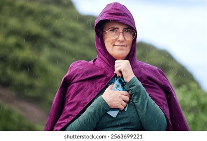 Portrait of active senior woman in raincoat and glasses looking away - Powered by Shutterstock