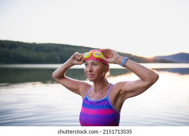 Portrait Of Active Senior Woman Swimmer Outdoors By Lake.