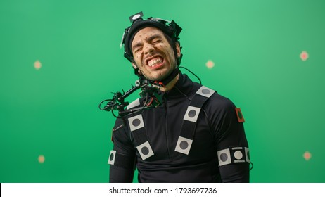 Portrait of an Actor Wearing Motion Caption Suit and Head Rig Posing with Green Screen Background. Film Studio Set Shooting Blockbuster Movie with Chroma Key. - Shutterstock ID 1793697736