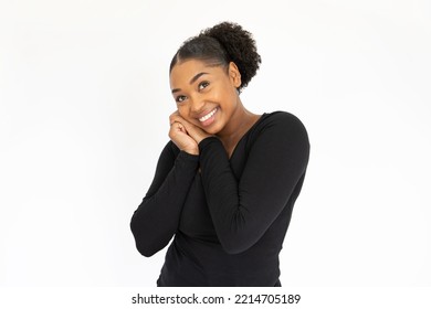 Portrait of admiring young woman posing against white background. African American lady wearing black longsleeve looking at camera with love and excitement. Admiration concept - Shutterstock ID 2214705189
