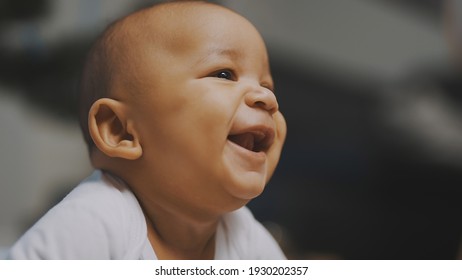 Portrait Of Adorable African American Black Baby. Baby Laughing While Having Tummy Time. High Quality Photo