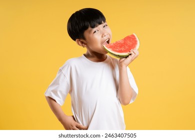 Portrait of adorable asian boy posing on yellow background - Powered by Shutterstock