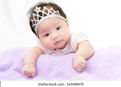 Portrait Of Adorable Baby Girl With Crown.