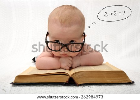 portrait of adorable baby in glasses counting in mind with handwritten thought tag with case study