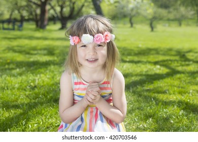 Portrait Of Adorable Blond Young Girl In Preschool Age Wearing Flowers In Hairs Outdoors In Traditional Swedish Midsummer Celebration 