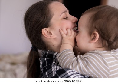 Portrait Adorable Face Of Little Cheerful Happy Toddler Baby Girl Child With Charming Smile Look At Mom Strong Cuddles Loving Mommy Together. Mother Hugs Play Love Care Kiss Smiling Daughter At Home