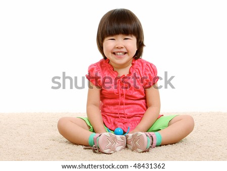 Portrait of adorable girl with smiling sitting on the floor