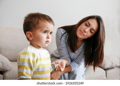 Portrait Of Adorable Little Boy Sitting On The Textile Couch With His Mom And Crying. Upset Toddler Throwing A Tantrum At Home. Barefoot Calling For Attention. Close Up, Copy Space, Background.