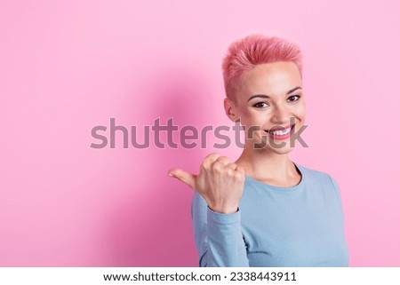 Portrait of adorable lovely positive girl wear trendy clothes demonstrate empty space interesting offer isolated on pink color background