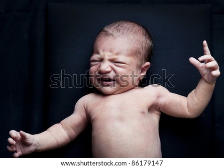 Baby yawning lying on a carpet