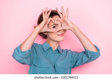 Portrait of adorable nice person arms fingers demonstrate heart symbol eye isolated on pink color background - Shutterstock ID 2201784511
