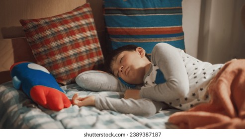 Portrait of Adorable South Korean Boy Waking up in His Bed in Beautiful Sunny Children's Room. Super Cute Kid Ready for a Sunny Day Full of Adventures like Going to School and Playing with Friends - Powered by Shutterstock