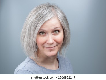 Portrait Of An Adorable Woman With Grey Hair In Her Early Fifties