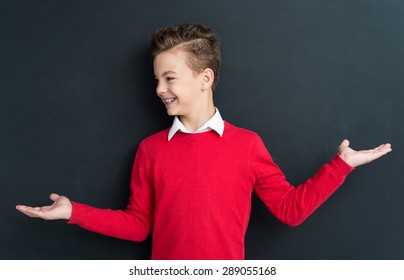 Portrait Of Adorable Young Boy 11 Years Old Posing At The Black Chalkboard In Classroom. 