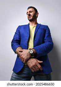 Portrait Of Adult Bearded Man In Modern Casual Clothing Blue Jeans, Jacket And Yellow T-shirt Standing Looking Down At Camera Over White Background