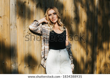 Similar – young girl standing near old building with wires