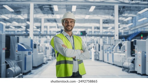 Portrait of Adult Caucasian Male Production Supervisor Looking at Camera And Smiling. Technician in Hardhat And Reflective Jacket at an Industrial Factory with Heavy Machinery Producing Electronics. - Powered by Shutterstock