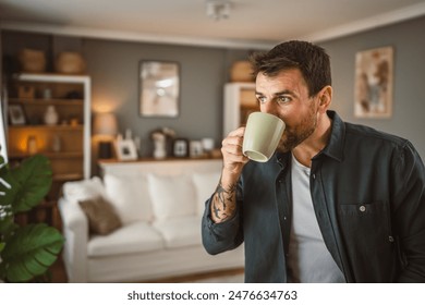 Portrait of adult handsome man drink first coffee in the living room - Powered by Shutterstock