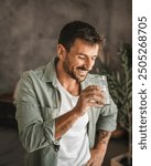 Portrait of adult handsome men stand and drink water at home