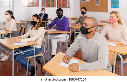 Portrait Of Adult Hispanic Man In Protective Face Mask During Lesson In Extension School. Concept Of Necessary Precautions In COVID Pandemic