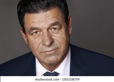 Portrait Of An Adult Man 60 Years Old, Close-up On A Black Background, Studio, Luxury Life, Advertising