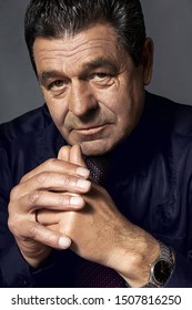 Portrait Of An Adult Man 60 Years Old, Close-up Wears A Wristwatch, On A Black Background, Studio, Luxury Life, Advertising