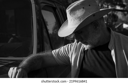 Portrait Of Adult Man In Cowboy Hat Standing Against A Vintage Truck