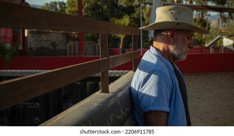 Portrait Of Adult Man In Cowboy Hat Standing Against A Vintage Truck During Sunset