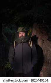 Portrait Of An Adult Man In A Hat With A Mosquito Net In Forest  In Summer