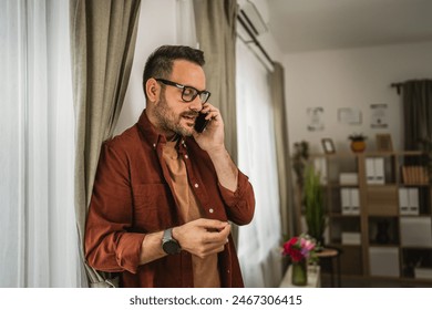 Portrait of adult nervous caucasian man stand while talk on mobile phone and - Powered by Shutterstock