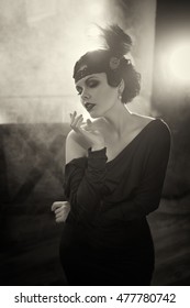 Portrait of adult pretty Flapper girl. Old photo in a retro style. Smoky eyes and hair cold wave.