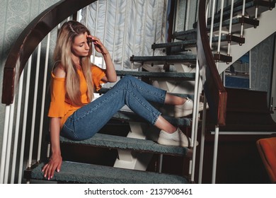 Portrait Adult Woman Actress Posing On Home Staircase Dressed Styling Clothes In Vintage Living Room. Female With Long Hair In Style Orange Jacket. Concept Retro Fashion And Outdated Trend Vogue