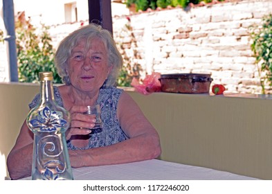 Portrait Of An Adult Woman Who Drinking Whiskey, Sad Face - Depression Concept. The Social Problem. Focus On A Bottle Of Alcohol . Lonelines, Anxiety Despair Senior Women. Big Mental Problems. Emotion