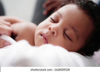 portrait of african american baby boy sleeping