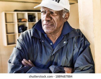 Portrait Of African American Baseball Coach Standing In Dugout